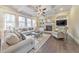 Inviting living room featuring a fireplace, built-in shelving, and plenty of natural light from large windows at 1438 Kings Park Nw Dr, Kennesaw, GA 30152