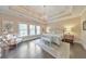 Spacious main bedroom with tray ceilings, abundant natural light, and stylish decor with hardwood floors at 1438 Kings Park Nw Dr, Kennesaw, GA 30152