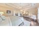 Beautifully staged main bedroom with tray ceiling, seating area, and stylish furnishings at 1438 Kings Park Nw Dr, Kennesaw, GA 30152