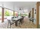 Spacious covered patio with an outdoor dining area, ceiling fans, and views of the pool at 1438 Kings Park Nw Dr, Kennesaw, GA 30152