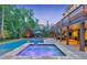Resort-style pool and spa with stone accents, complemented by an outdoor kitchen and covered patio at 1438 Kings Park Nw Dr, Kennesaw, GA 30152