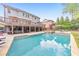 Backyard oasis featuring a large swimming pool, spa, and covered outdoor living area with a deck at 1438 Kings Park Nw Dr, Kennesaw, GA 30152