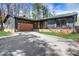 Charming one-story home featuring a wooden garage door and a well-maintained front yard at 3650 Dogwood Farm Rd, Decatur, GA 30034