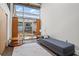 Bright bedroom with modern furnishings, a seating area, and a large window at 659 Auburn Avenue Ne #219, Atlanta, GA 30312