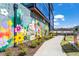 Exterior view highlighting the building's vibrant floral mural and landscaped walkway, enhancing the property's curb appeal at 659 Auburn Avenue Ne #219, Atlanta, GA 30312