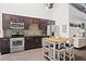 Bright kitchen boasts modern appliances, dark cabinetry, and an island with seating at 659 Auburn Avenue Ne #219, Atlanta, GA 30312