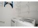 Bright laundry room featuring a modern washer and dryer, complemented by convenient wire shelving for organized storage at 659 Auburn Avenue Ne #219, Atlanta, GA 30312