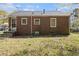 Back view of brick home with a small patio area and well-maintained backyard at 854 Slaton St, Forest Park, GA 30297