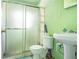 Compact bathroom featuring a sliding glass shower door and simple fixtures at 854 Slaton St, Forest Park, GA 30297