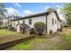 Well maintained backyard with garden beds, trees, grass, and exterior of the home at 1780 John Calvin Ave, Atlanta, GA 30337