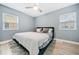 Bedroom with plush carpet, a ceiling fan, and natural light from two windows at 1780 John Calvin Ave, Atlanta, GA 30337