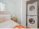Bedroom with stacked washer and dryer and comfortable bed at 1780 John Calvin Ave, Atlanta, GA 30337