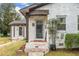 Close up on front door with 'R' on it and small porch and adjacent smaller structure at 1780 John Calvin Ave, Atlanta, GA 30337