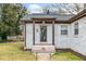Close up on front door with 'L' on it and small porch and dark roof at 1780 John Calvin Ave, Atlanta, GA 30337