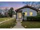 Charming white brick home with inviting walkway lighting and well-maintained lawn at dusk at 1780 John Calvin Ave, Atlanta, GA 30337