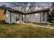 Charming white brick home with inviting walkway lighting and well-maintained lawn at dusk at 1780 John Calvin Ave, Atlanta, GA 30337