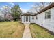 Charming house boasts a manicured lawn, walkway, and inviting entrance with decorative lighting at 1780 John Calvin Ave, Atlanta, GA 30337