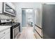 Updated kitchen features stainless steel appliances, mosaic backsplash, and sleek countertops at 1780 John Calvin Ave, Atlanta, GA 30337