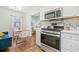 Updated kitchen with stainless steel appliances, white cabinetry, dining nook and natural light at 1780 John Calvin Ave, Atlanta, GA 30337