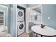 Laundry area featuring a stacked washer and dryer and natural light at 1780 John Calvin Ave, Atlanta, GA 30337