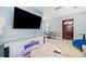 Modern living room with electric fireplace, television, sitting area and dark wood door at 1780 John Calvin Ave, Atlanta, GA 30337