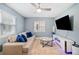 Comfortable living room featuring a neutral sofa with blue pillows and a large TV at 1780 John Calvin Ave, Atlanta, GA 30337