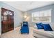 Comfortable living room featuring a neutral sofa with blue pillows and a dark wood door at 1780 John Calvin Ave, Atlanta, GA 30337