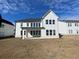 Rear elevation view of a white two-story home with a brick foundation and unfinished backyard at 2155 Suncrest Point, Marietta, GA 30064