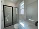 Modern bathroom featuring a glass shower enclosure, sleek fixtures, and bright natural light at 2155 Suncrest Point, Marietta, GA 30064