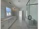Well-lit bathroom with a double sink vanity, soaking tub, and seamless glass shower at 2155 Suncrest Point, Marietta, GA 30064
