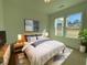 Bright bedroom features large windows, soft color palette, and stylish decor for a comfortable and relaxing space at 2155 Suncrest Point, Marietta, GA 30064