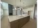 Open kitchen features an island with stone countertops, modern appliances and provides great flow at 2155 Suncrest Point, Marietta, GA 30064