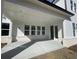 Covered patio with white brick accents offers a versatile outdoor space for relaxing and entertaining at 2155 Suncrest Point, Marietta, GA 30064
