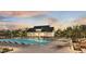 Community swimming pool boasts comfortable lounge seating and sunset views with a covered outdoor dining area at 2155 Suncrest Point, Marietta, GA 30064