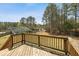 Inviting backyard view from the deck showcasing a tranquil, tree-lined perimeter at 248 Christian Circle, Carrollton, GA 30116