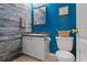 Cozy bathroom featuring wainscoting, a granite countertop, and vibrant blue walls at 248 Christian Circle, Carrollton, GA 30116