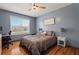 Cozy bedroom with wood floors, a ceiling fan, and a double window overlooking the yard at 248 Christian Circle, Carrollton, GA 30116