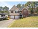Inviting two-story home with brick and vinyl siding, a two-car garage, and a cozy front porch at 248 Christian Circle, Carrollton, GA 30116