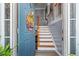 Bright foyer with a staircase, featuring a 'Welcome' sign on the entry door at 248 Christian Circle, Carrollton, GA 30116