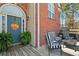Inviting front porch with striped seating and a 'Welcome' sign, complemented by lush green plants at 248 Christian Circle, Carrollton, GA 30116
