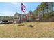 A well-maintained front yard and two story home, with a flag and a charming deck at 248 Christian Circle, Carrollton, GA 30116