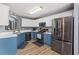 Modern kitchen with stainless steel appliances, white countertops, and stylish blue cabinets at 248 Christian Circle, Carrollton, GA 30116