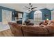 Comfortable living room with a stone fireplace, vaulted ceilings, a ceiling fan, and plush leather seating at 248 Christian Circle, Carrollton, GA 30116