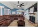Spacious living room with stone fireplace, vaulted ceilings, ceiling fan and an oversized sectional couch at 248 Christian Circle, Carrollton, GA 30116