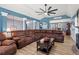 Expansive living room featuring a stone fireplace, large sectional, and an open view to the dining area at 248 Christian Circle, Carrollton, GA 30116