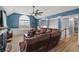 Comfortable living room boasts a leather sofa, vaulted ceilings, and abundant natural light at 248 Christian Circle, Carrollton, GA 30116