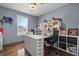 Home office setup with desk, chair, and storage shelves illuminated by natural light at 248 Christian Circle, Carrollton, GA 30116