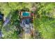 Aerial view of a private backyard with pool and deck surrounded by mature landscaping and woods at 4983 Odins Way, Marietta, GA 30068