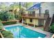Elevated view of backyard featuring a pool, deck, privacy landscaping, and two-story home at 4983 Odins Way, Marietta, GA 30068