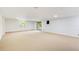 Large basement features sliding glass doors to the yard, carpet, and neutral walls at 4983 Odins Way, Marietta, GA 30068